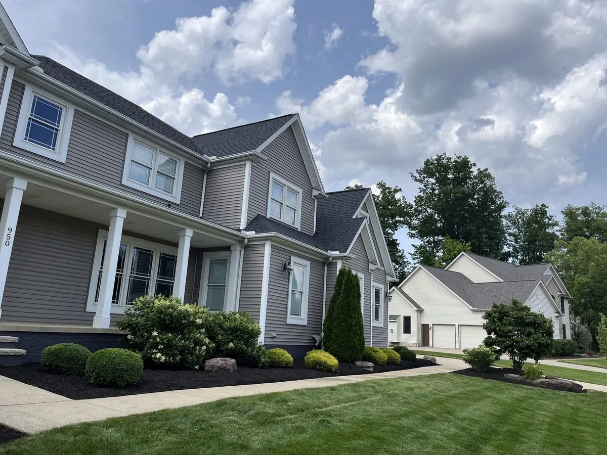 Curving driveway with striped front lawn
