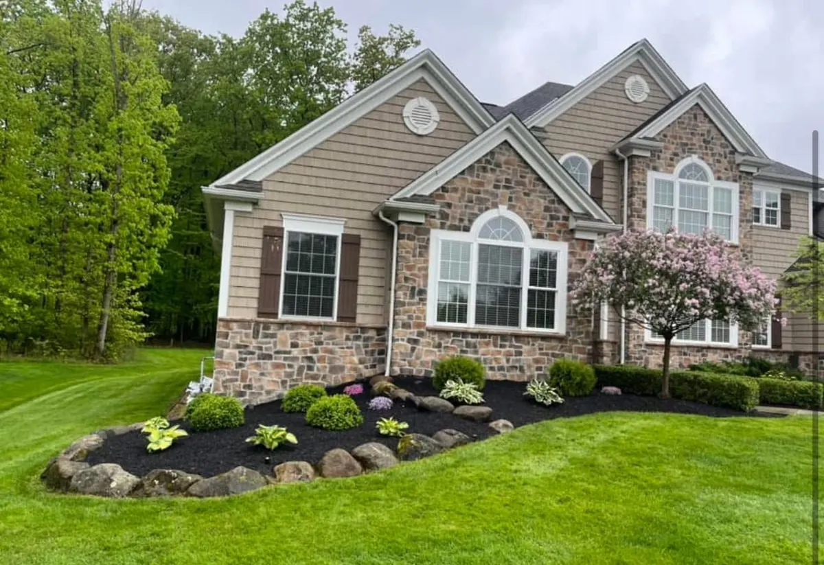 Stone home with fresh mulch beds