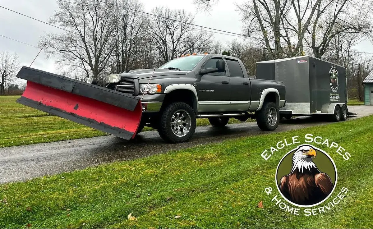Eagle Scapes truck with snow plow and branded trailer